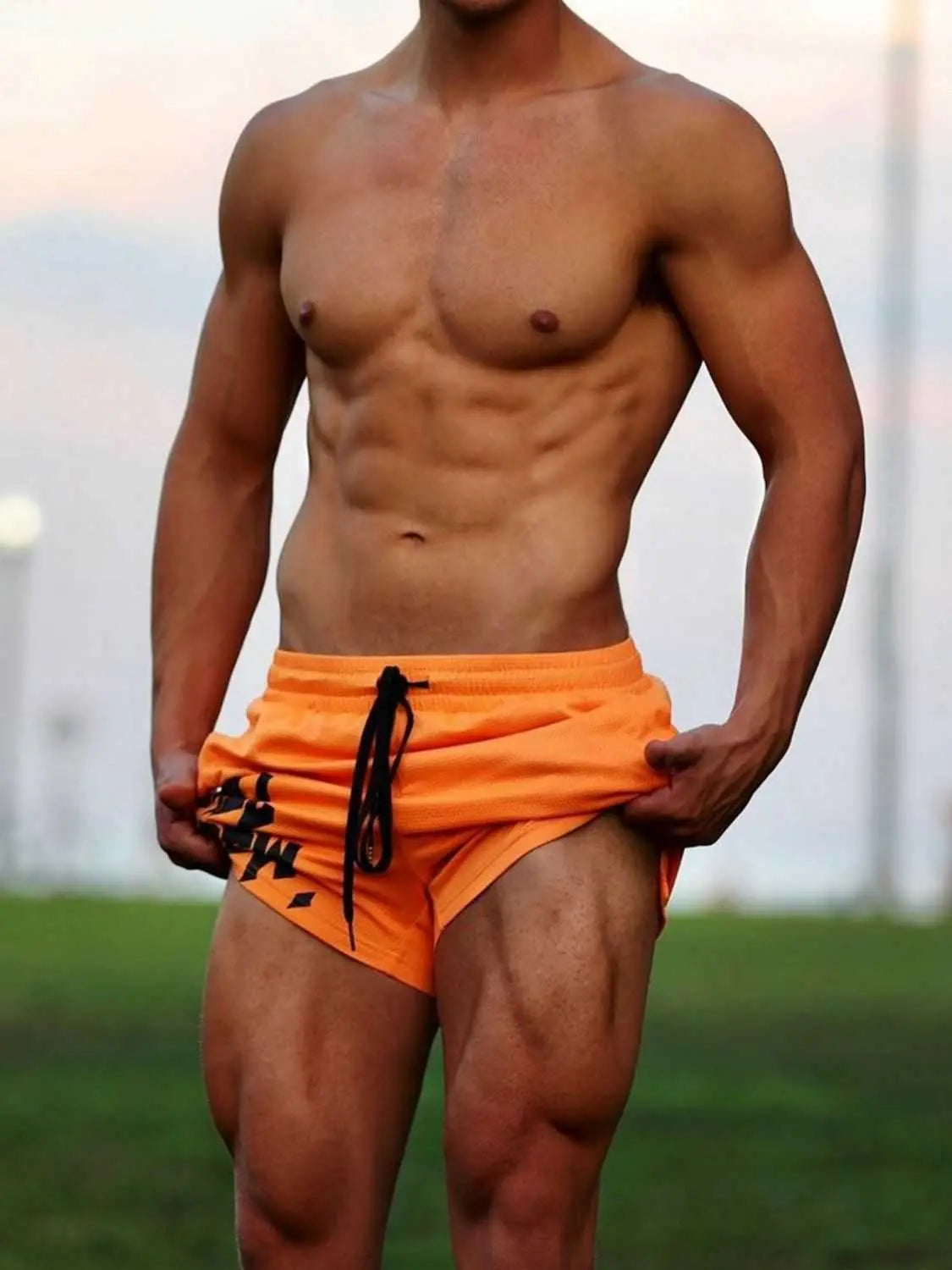 Men's plus size drawstring active shorts in orange, moderate stretch, polyester-spandex blend, basic style.