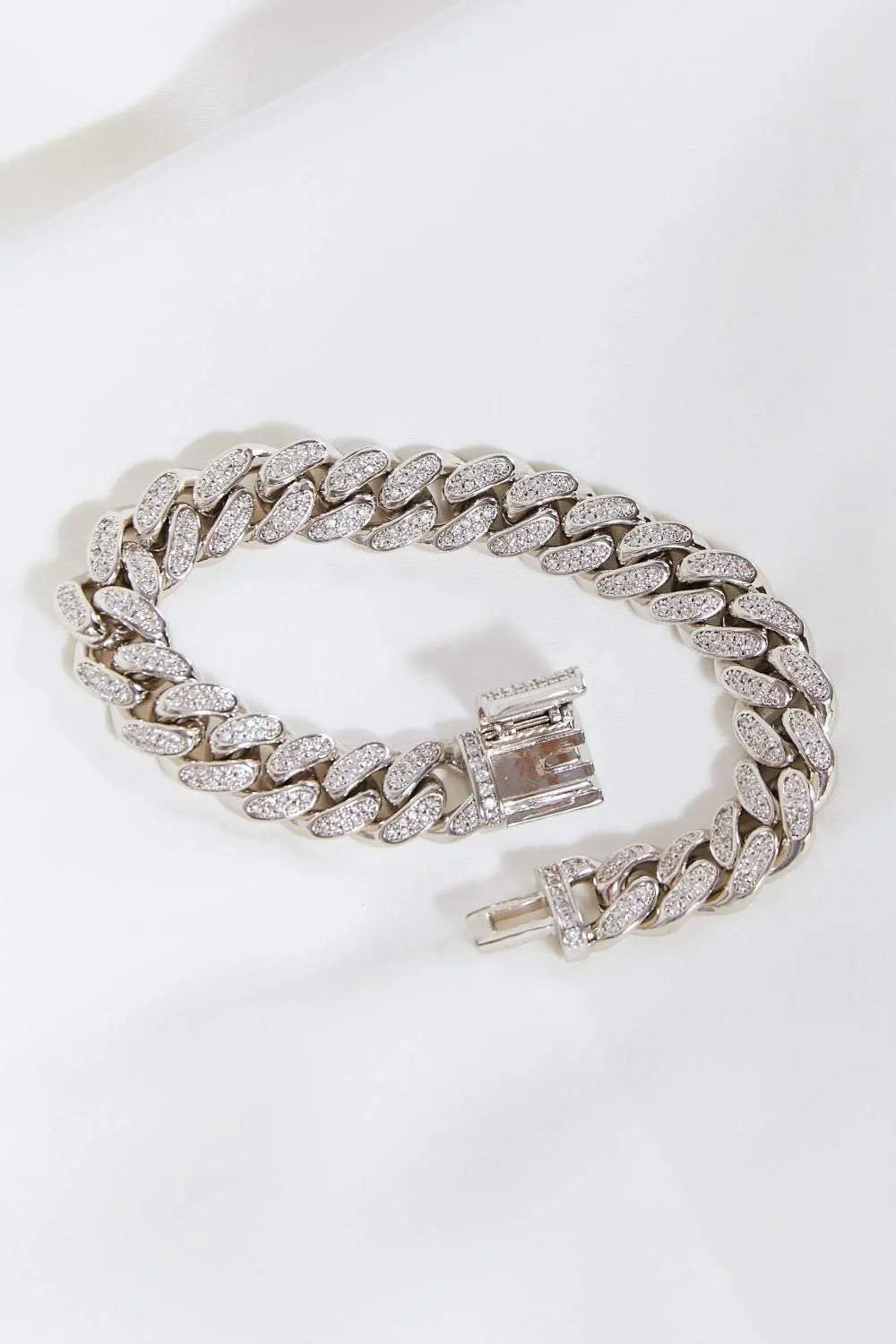 Curb chain bracelet in brass flat lay style.