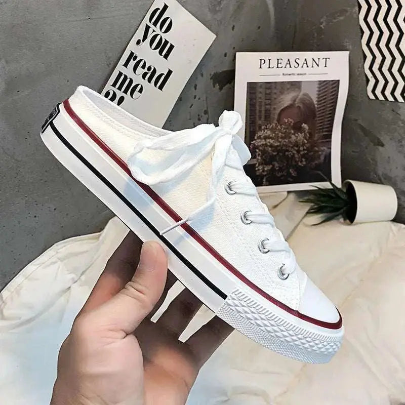 Round toe lace-up canvas sneakers with flat rubber sole.