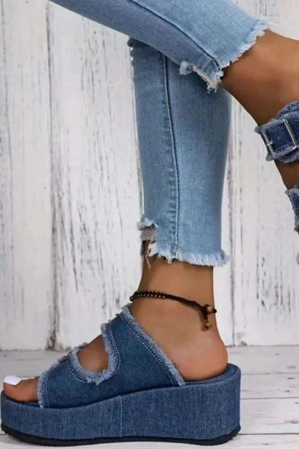 Raw hem wedge buckle sandals with mid heels in blue denim.