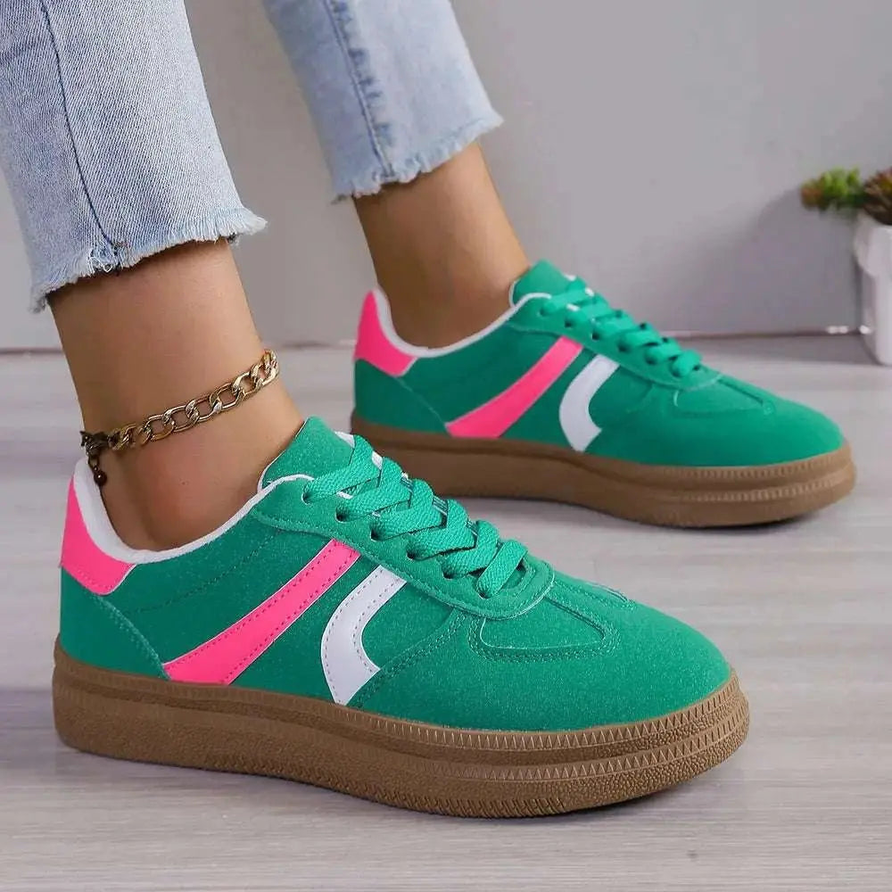 Lace up round toe contrast sneakers with green PU leather, pink and white accents, and rubber soles.