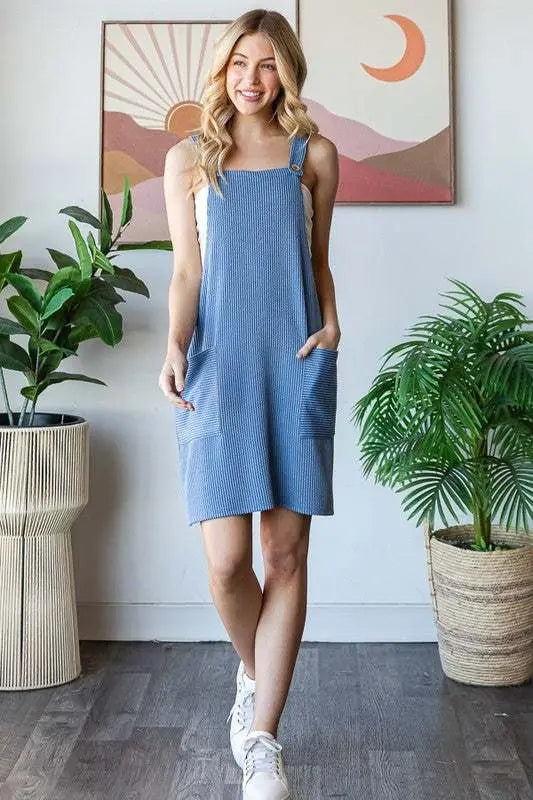 Heimish full size ribbed sleeveless mini tank dress for plus size women, featuring pockets and buttons.