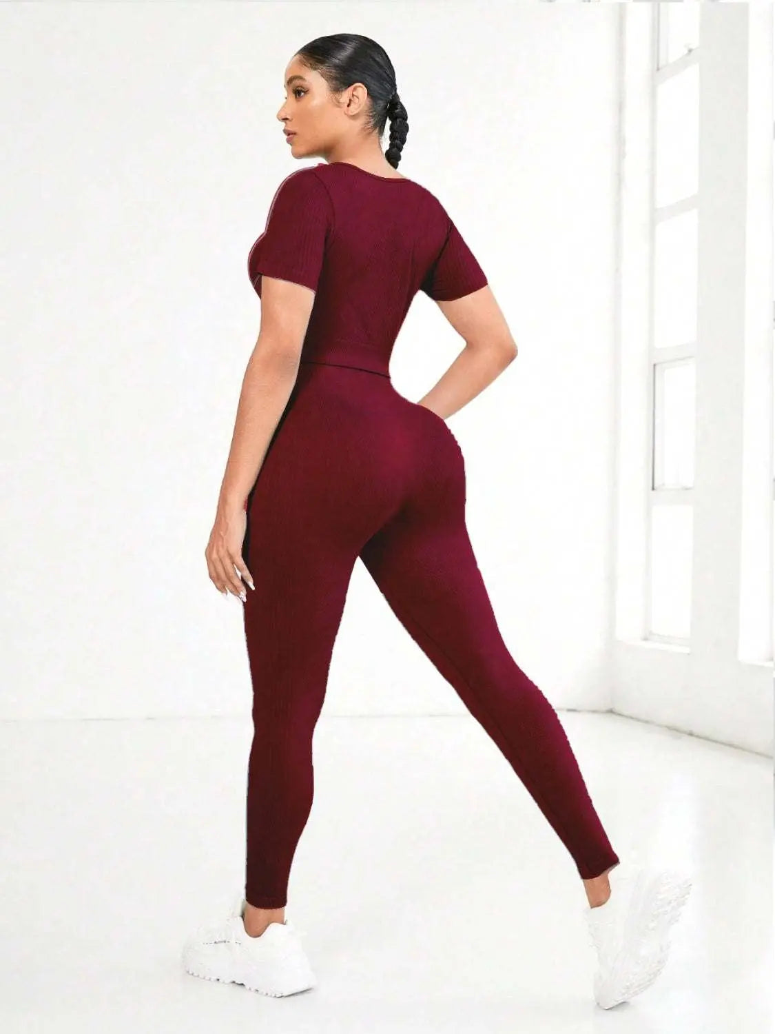 Round neck short sleeve top and leggings active set in burgundy, shown from the back.