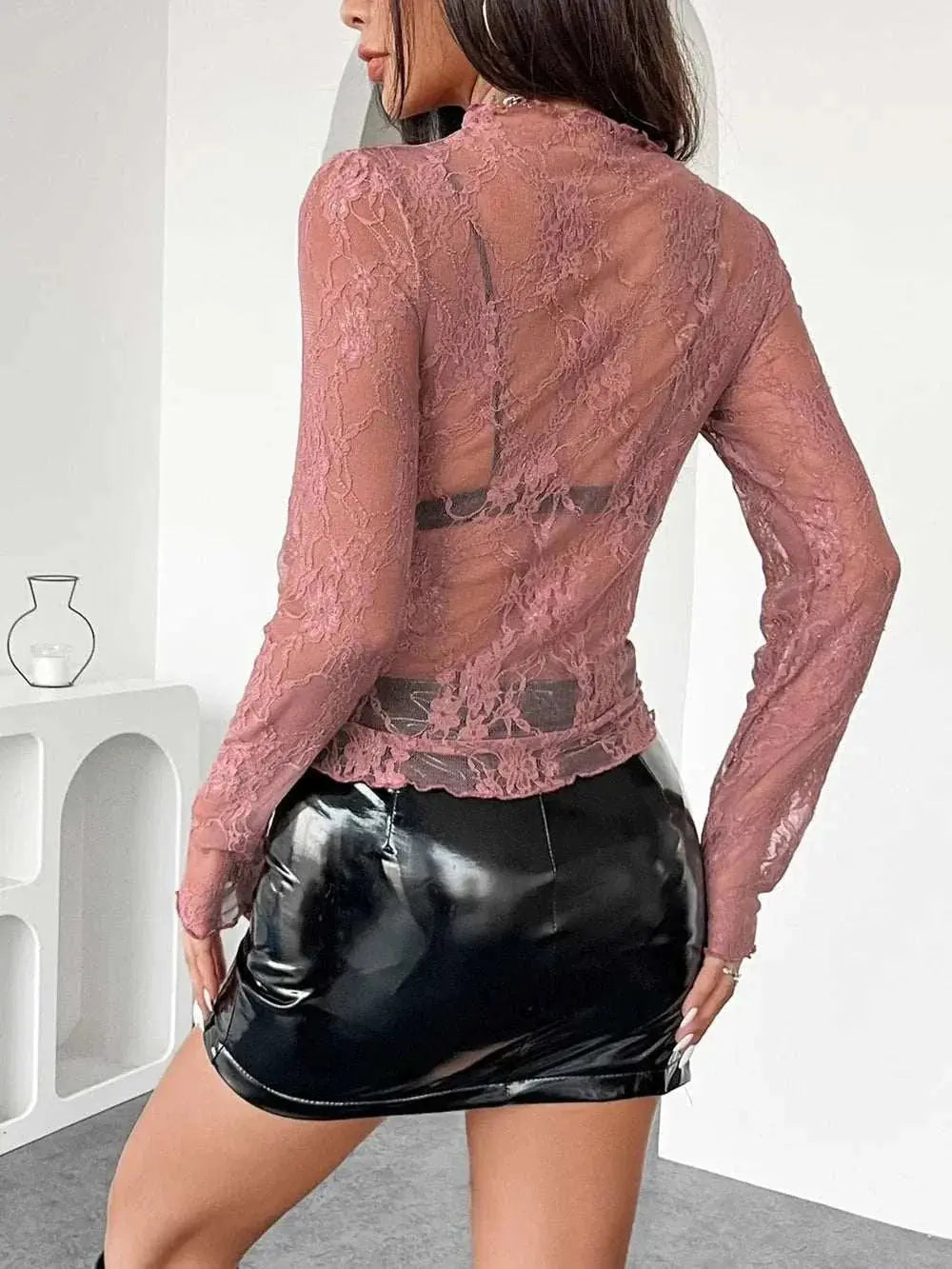 Mock neck long sleeve sheer lace top in pink, slightly stretchy polyester, worn with black vinyl skirt.