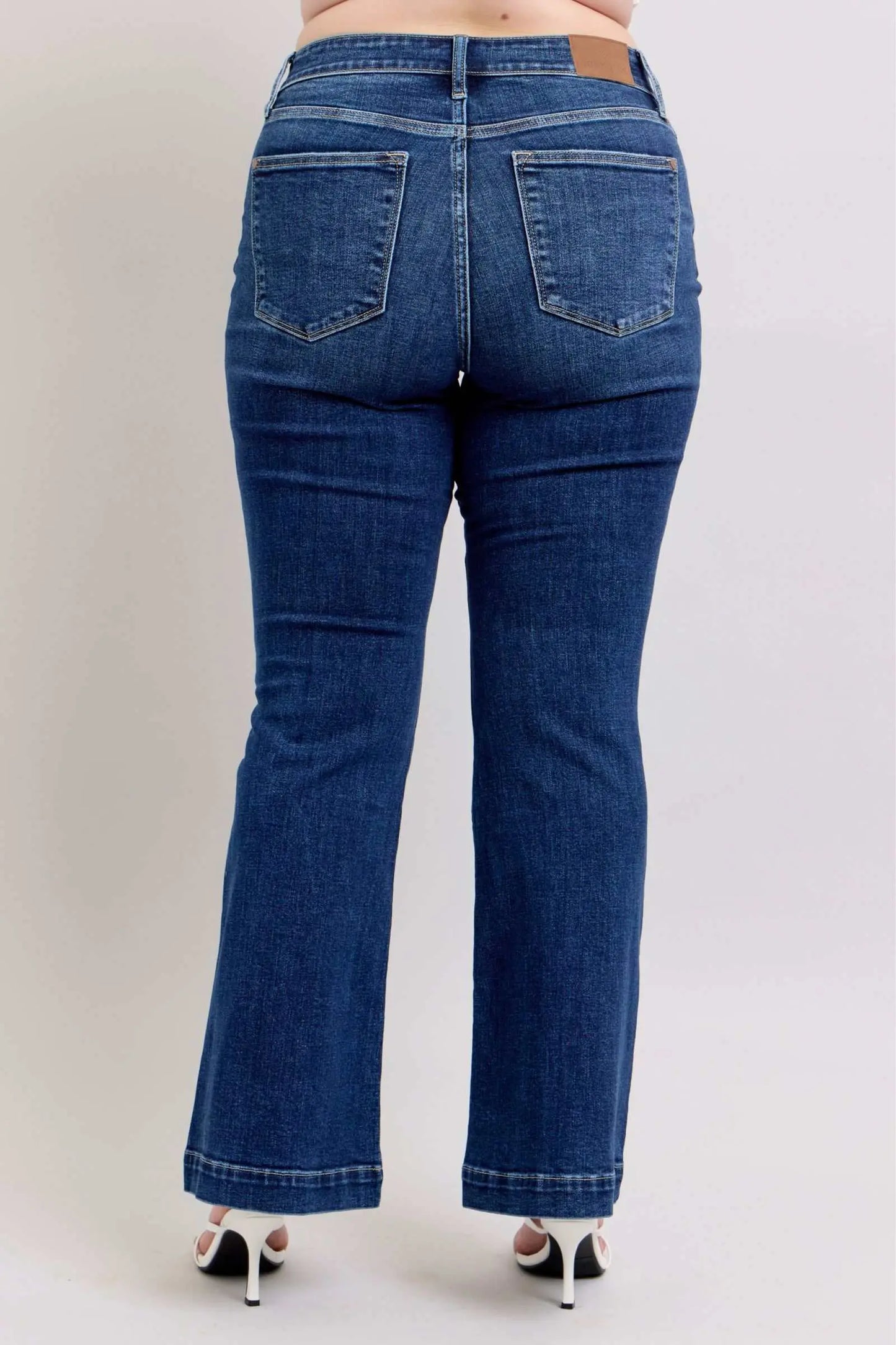 Judy Blue full-size high-rise flare jeans with pockets in plus size, featuring a flattering silhouette and chic retro style.