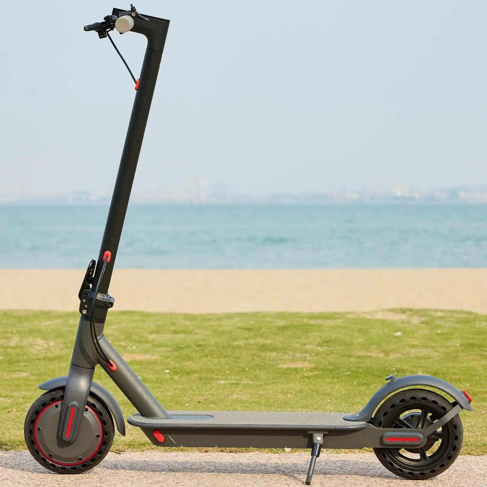 OAKEROO G5.0 Electric Scooter with 21-mile range, 19MPH speed, and folding design on a beach pathway.