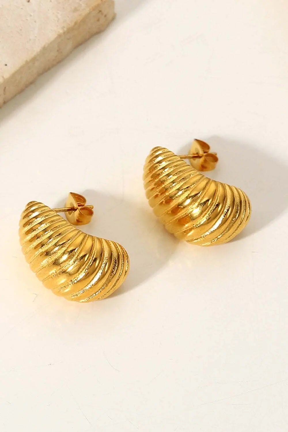 Gold Seashell Stud Earrings with seashell texture.