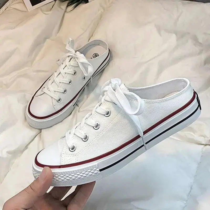 Round toe lace-up canvas sneakers in white with red and black stripes.