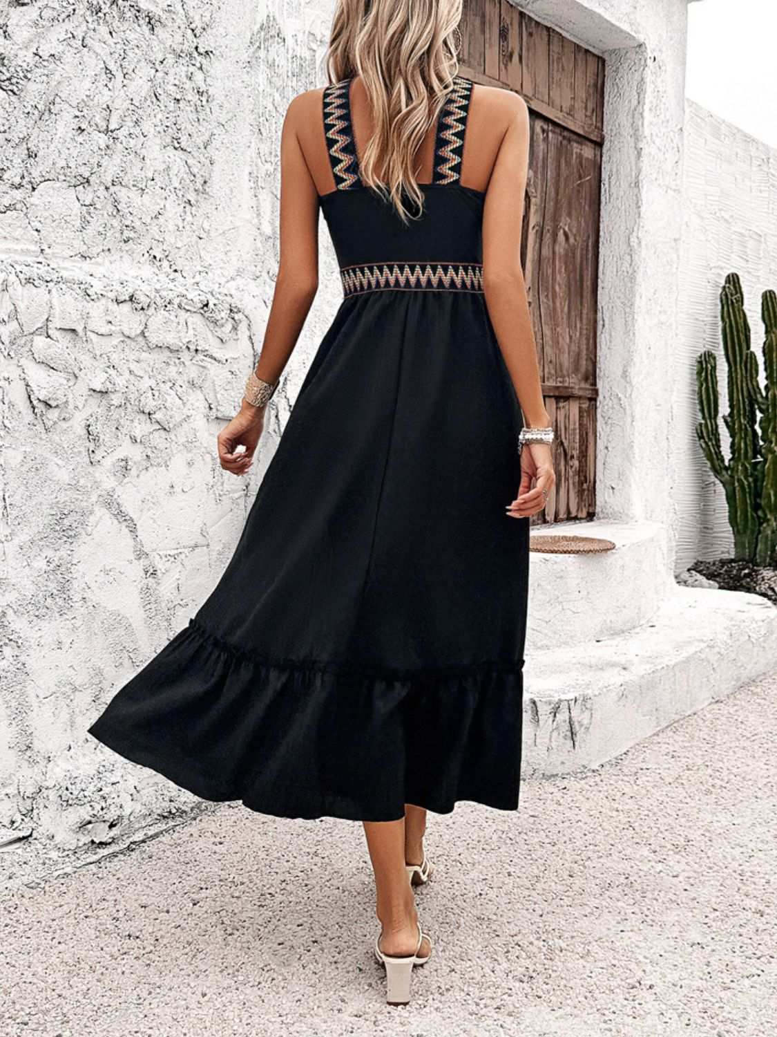 Devine Ruffled Slit Sleeveless Midi Dress in black with ruffled hem and zigzag detailing on straps and waist, back view.