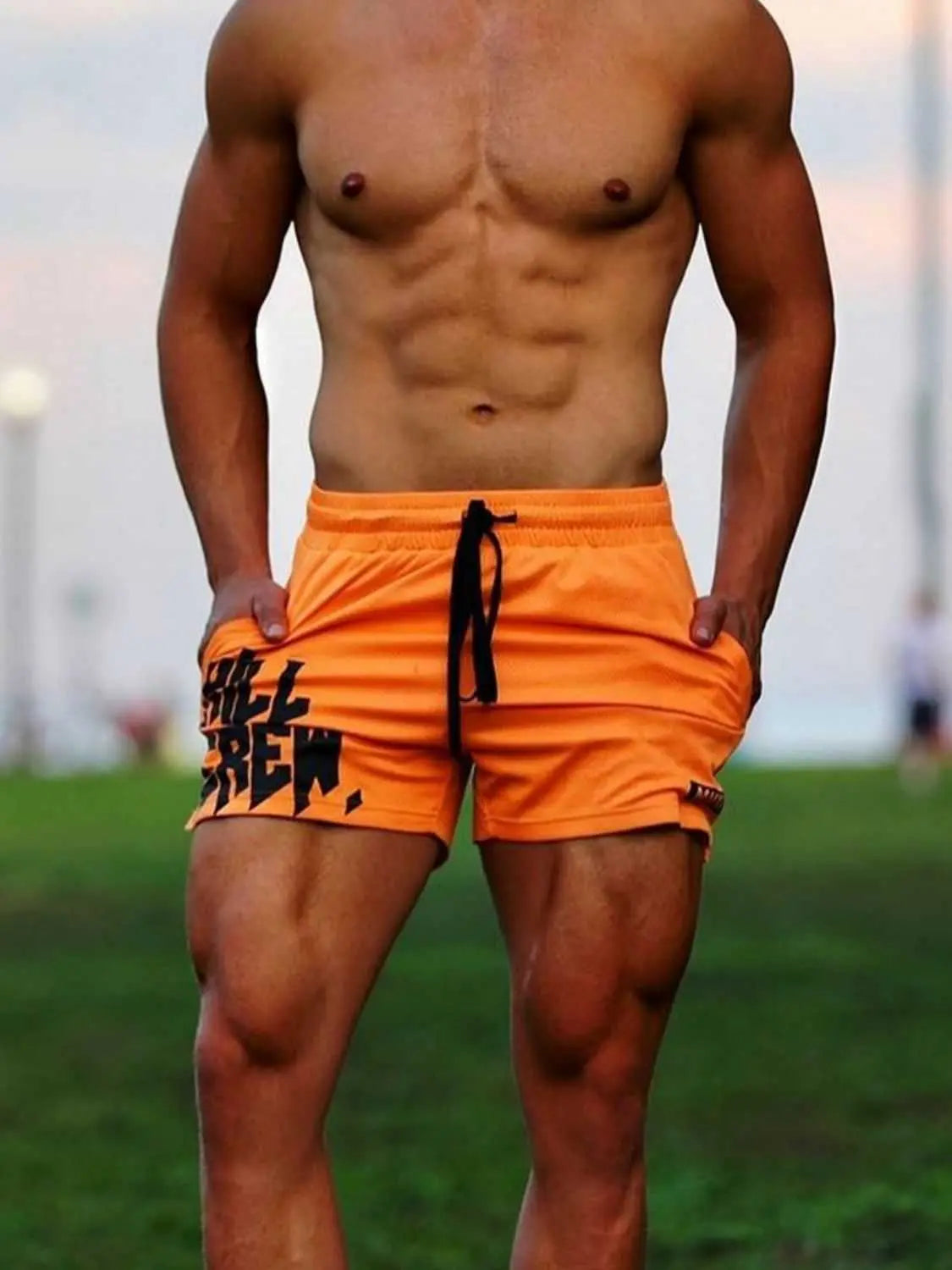 Men's plus size drawstring active shorts in orange, featuring moderate stretch and basic style, composed of polyester and spandex.