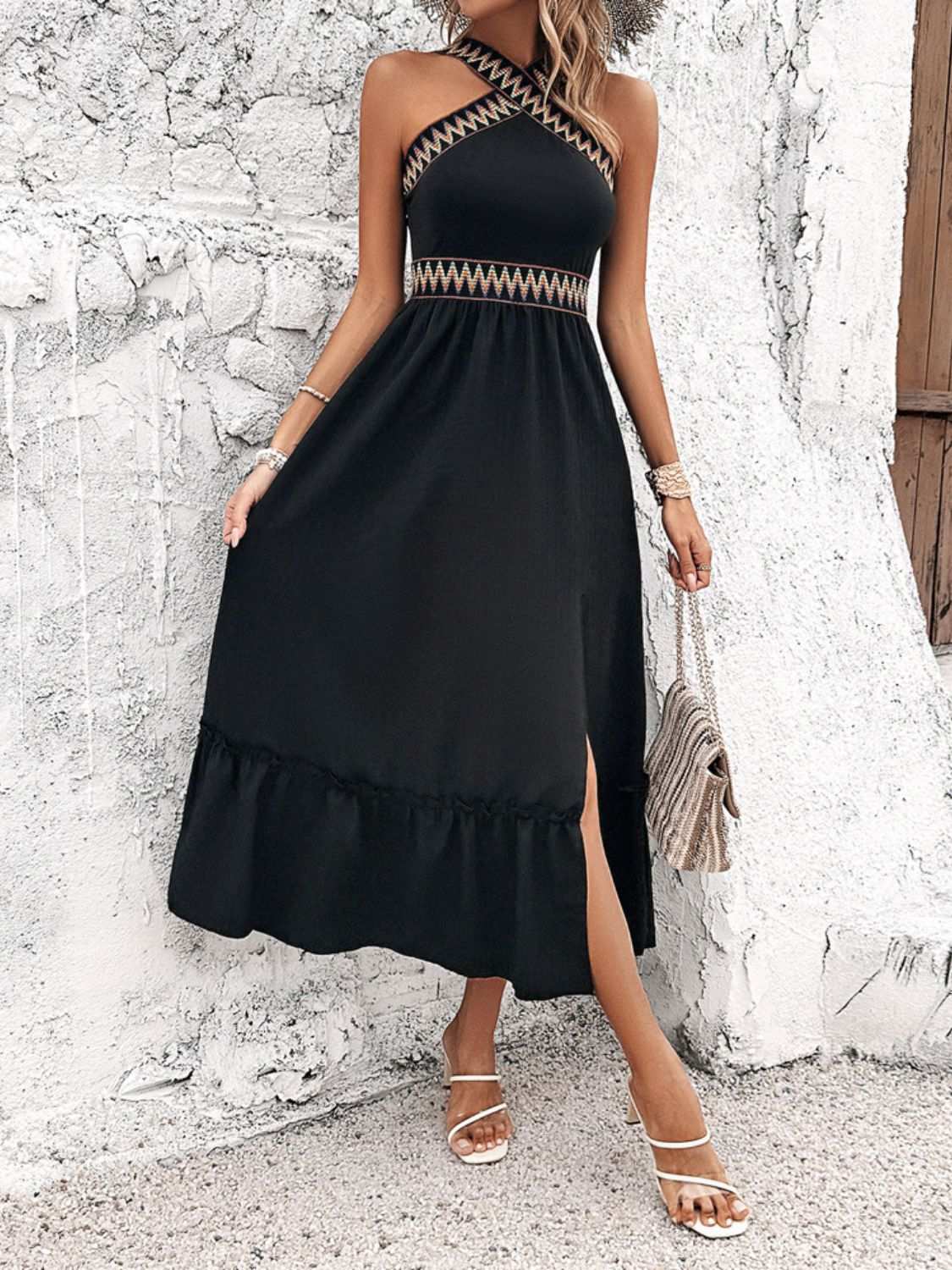 Devine Ruffled Slit Sleeveless Midi Dress in black with ruffled hemline and side slit.