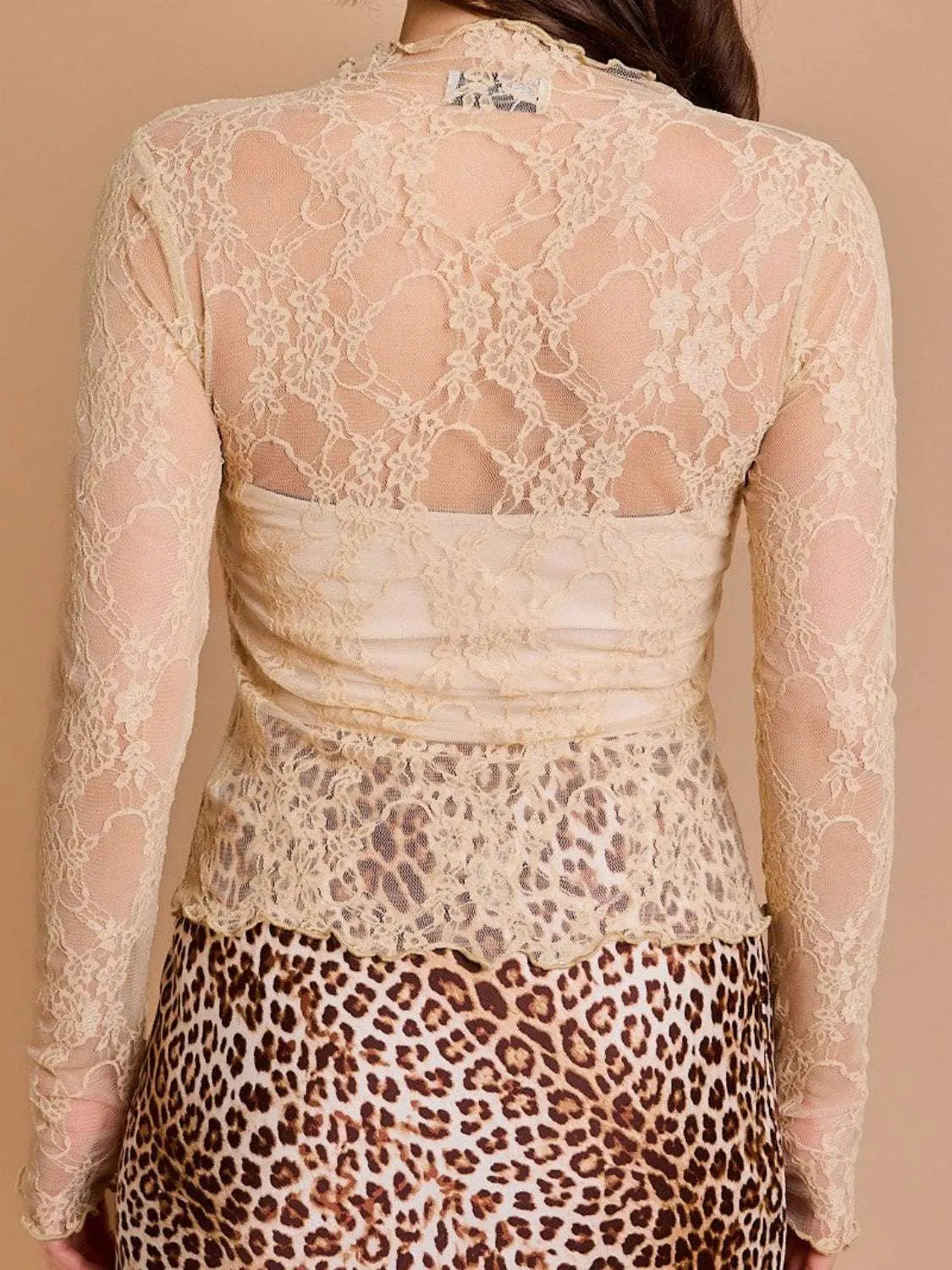 Lace mock neck long sleeve top, sheer and slightly stretchy, in beige, back view.