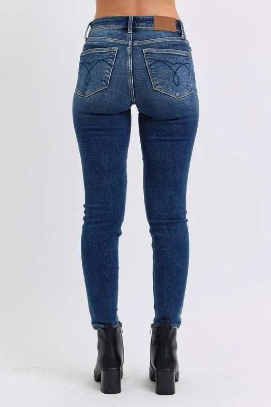 Judy Blue Full Size Run Mid-Rise Skinny Jeans with Thermal Lining, back view, highlighting pockets and denim finish.