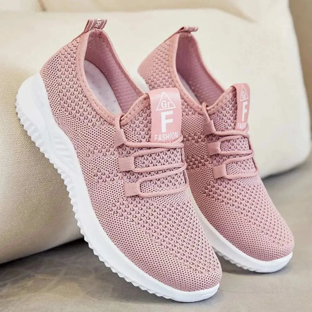 Breathable mesh lace-up athletic shoes in pink with rubber soles, designed for a true fit and comfort.