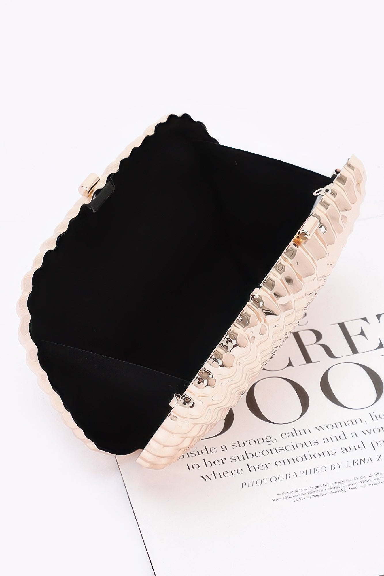 Interior view of the metallic clutch showing compact space for essentials