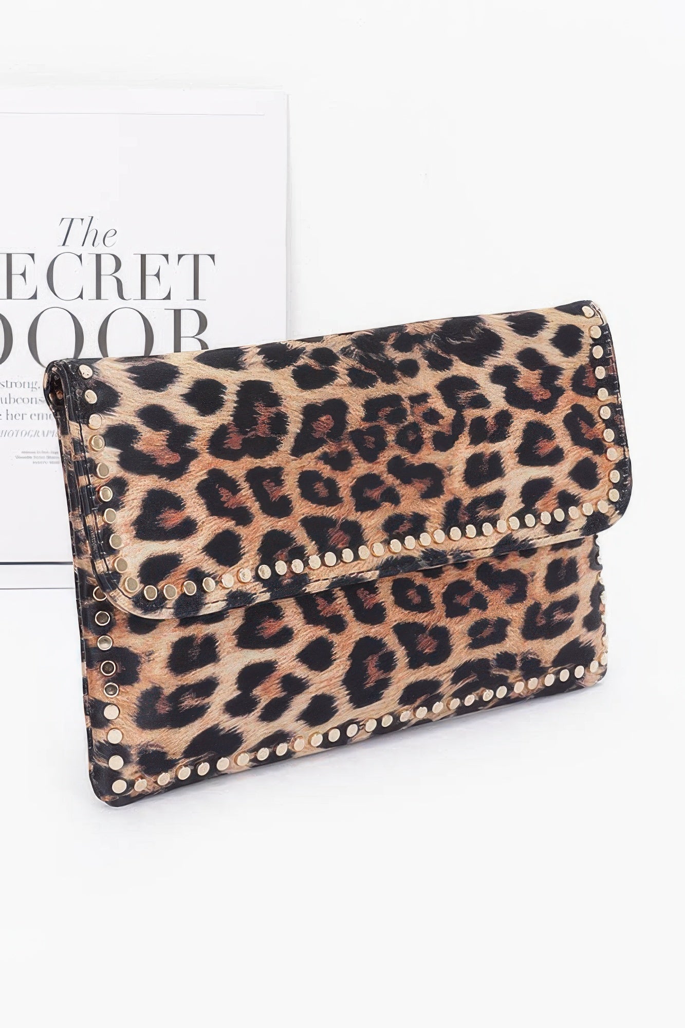 Front view of leopard clutch bag with metal studs and sleek nylon finish