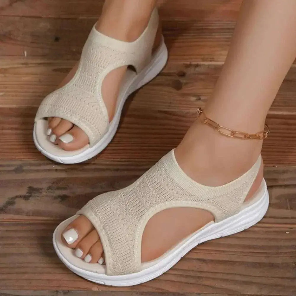 Peep toe solid color sandals made of rubber and cloth with flat heels.