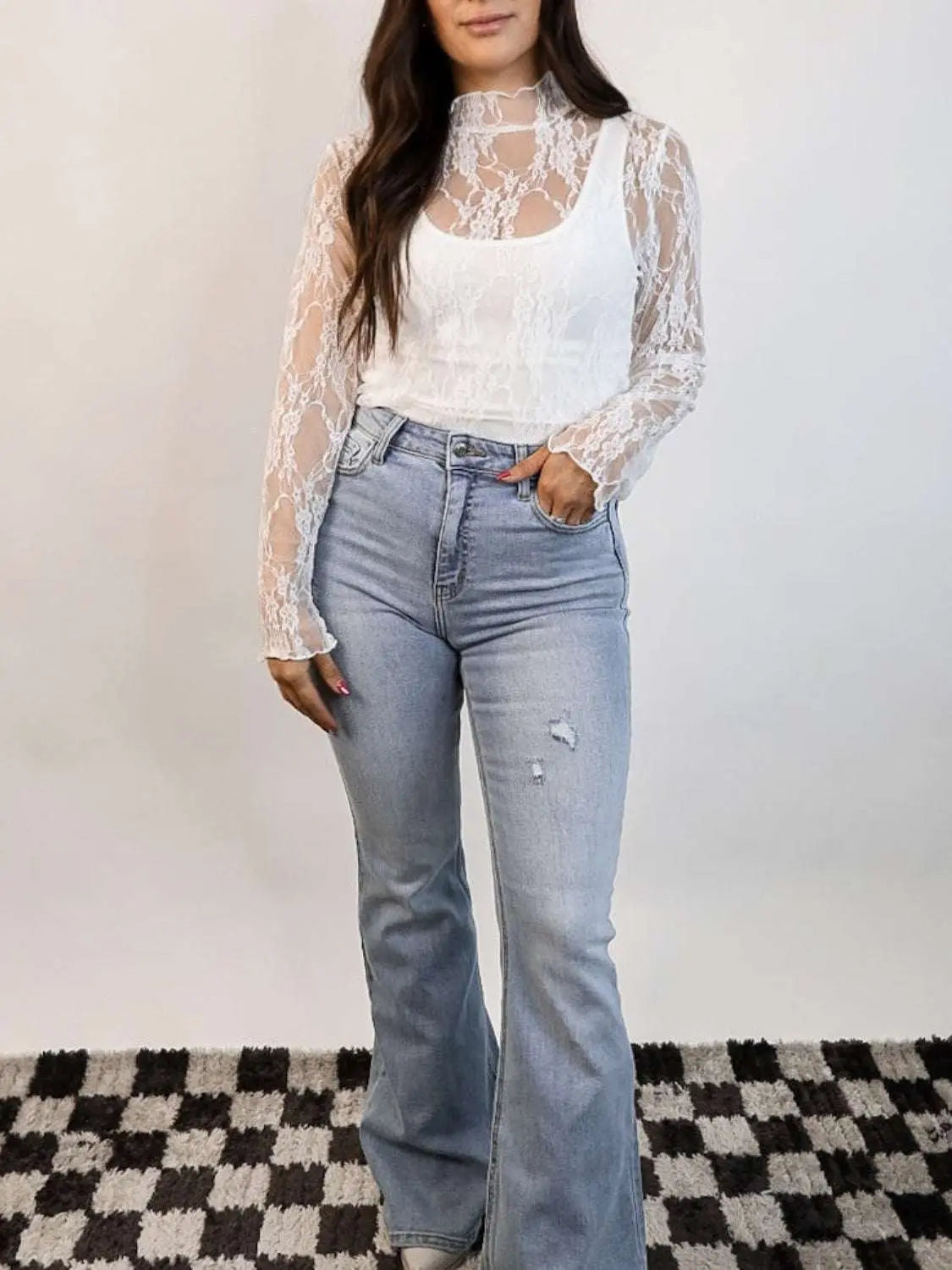 Lace mock neck long sleeve top with sheer design and slightly stretchy fabric.