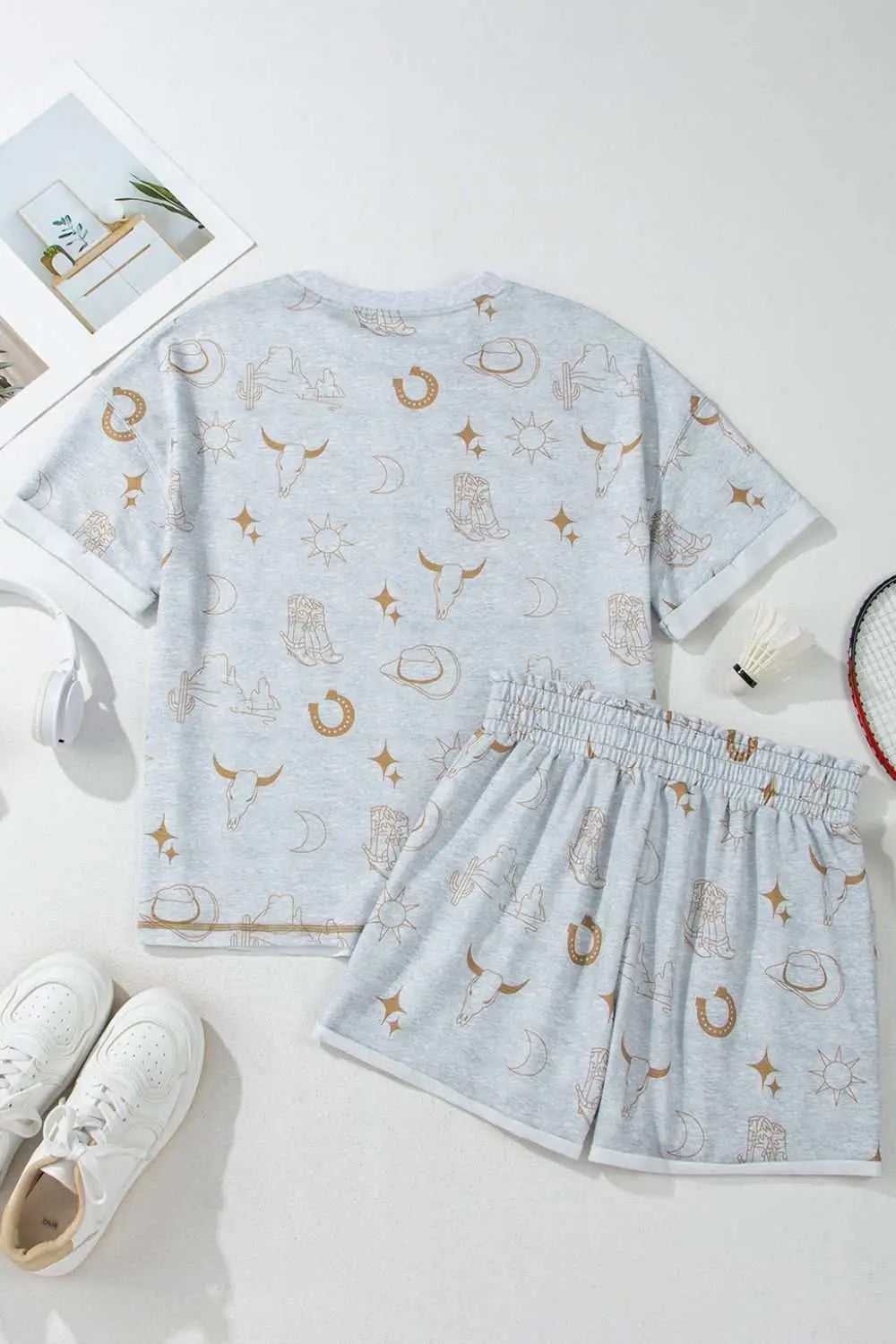 Printed T-shirt and shorts set with elastic waist, featuring a light grey base and brown patterns.