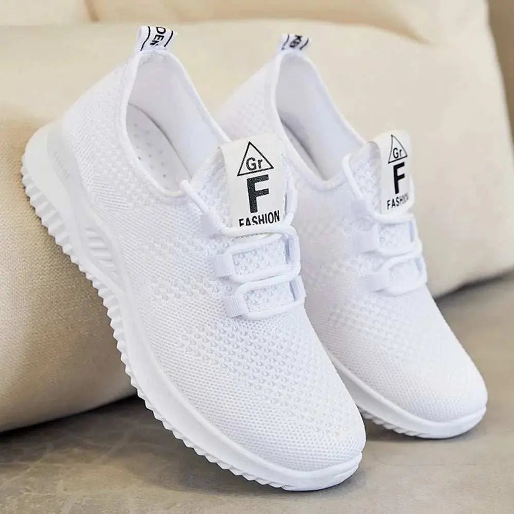 Breathable mesh lace-up athletic shoes in white, featuring a flat heel and rubber sole.