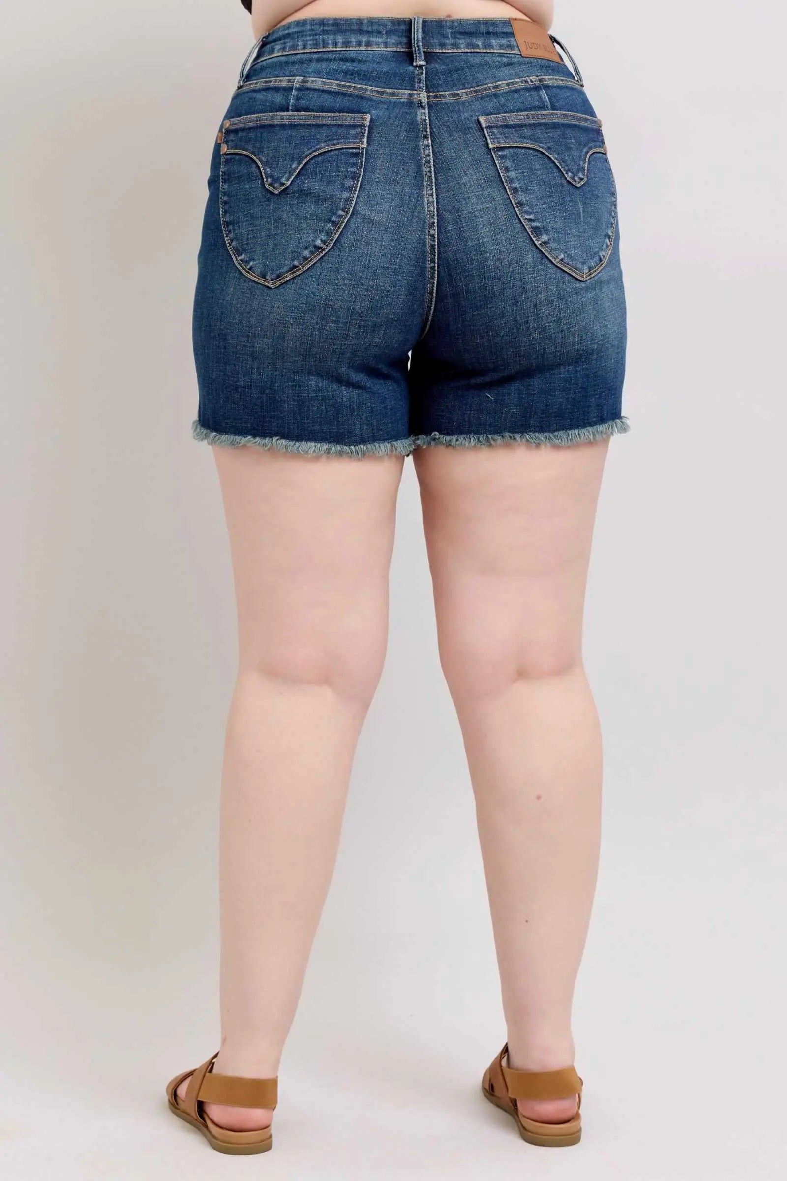 Judy Blue Tummy Control denim shorts with fray hem and shield back pockets.