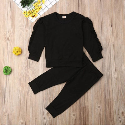 Newborn ruffle jumper 2-piece set in black with long sleeve top and pants, crafted from high-quality cotton for comfort and breathability, ideal for fall.