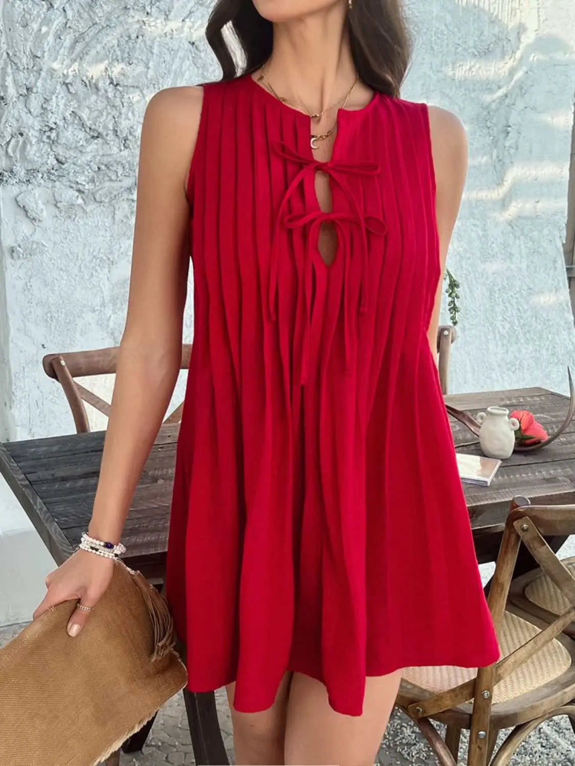 Devine Pleated Sleeveless Mini Dress in vibrant red with tie detail.