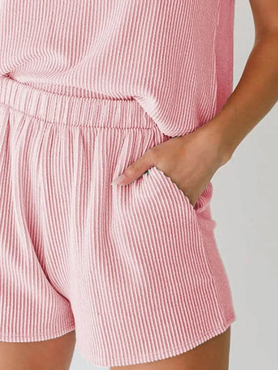 Round neck sleeveless top and shorts set with pockets made from slightly stretchy polyester blend.