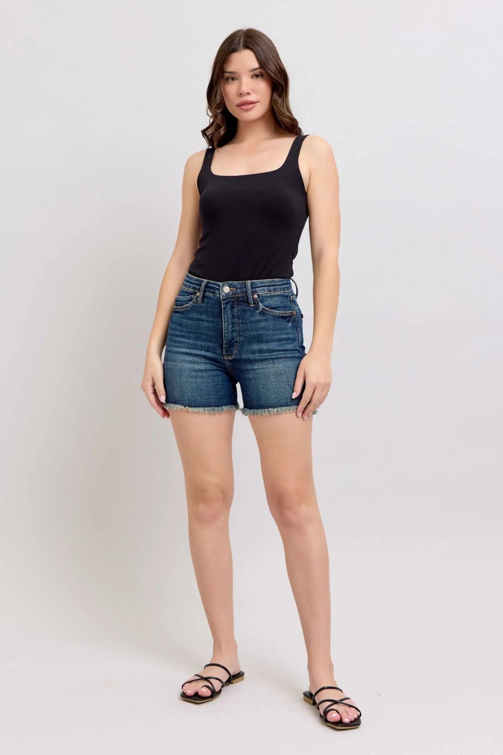 Judy Blue tummy control denim shorts with fray hem and shield back pockets.