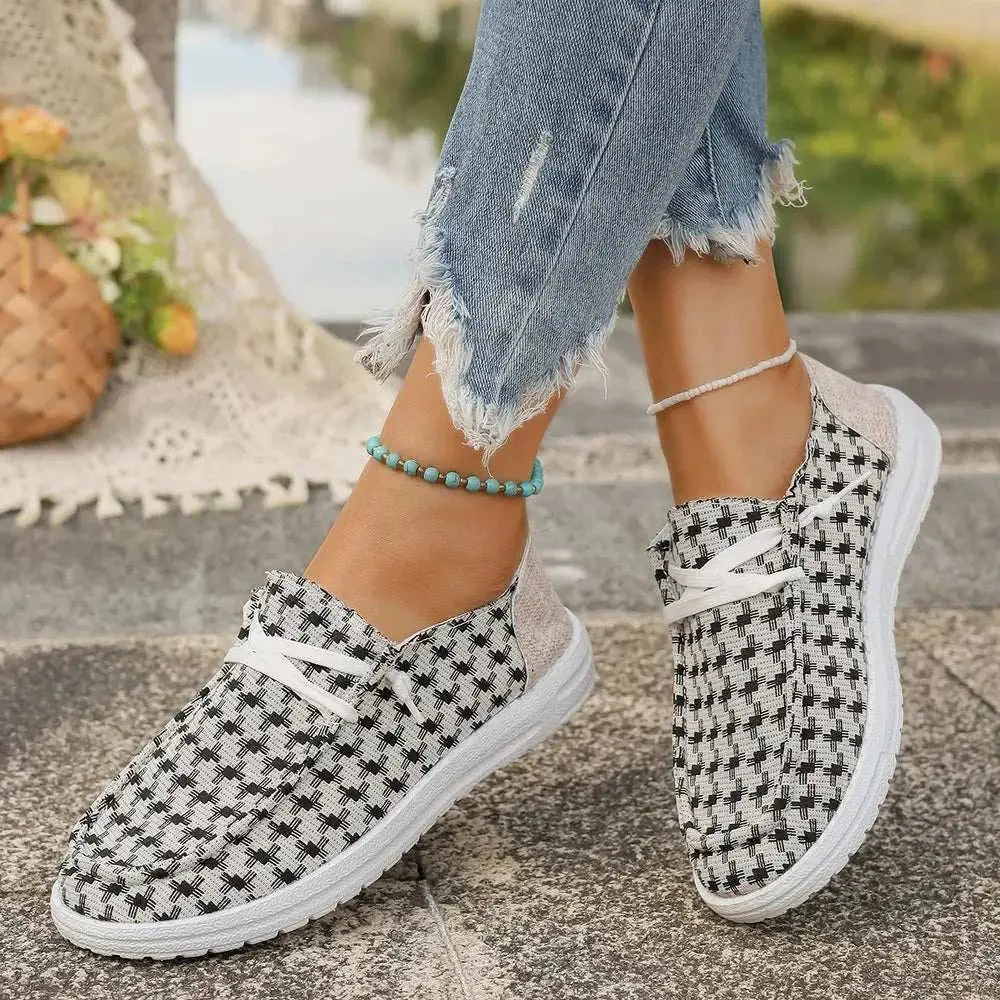 Plaid round toe canvas slip-ons with rubber soles, worn with ripped jeans and a beaded anklet.