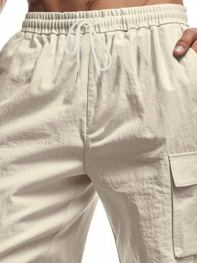 Men's full size drawstring shorts with cargo pockets in beige, polyester material.