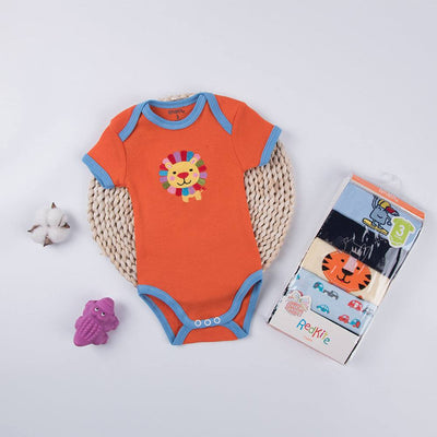 Baby Triangle Harmony Set with orange lion onesie on woven mat, purple toy, cotton fabric for little ones.