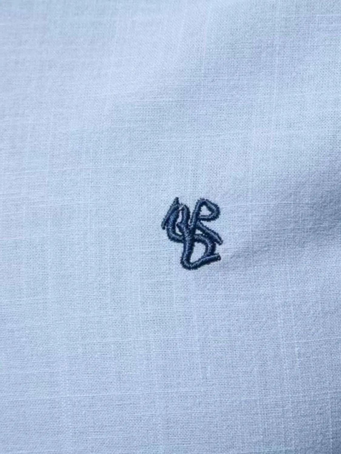 Embroidered detail on men's full size button down shirt, 100% cotton.