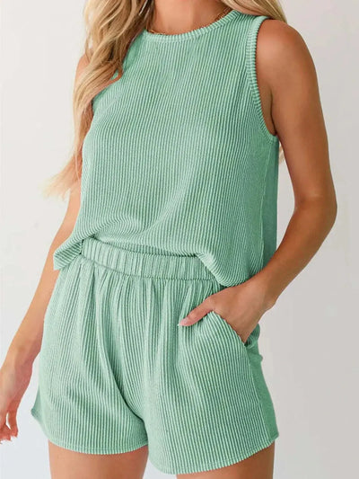 Round neck sleeveless top and shorts set in green, pocketed, slightly stretchy fabric.