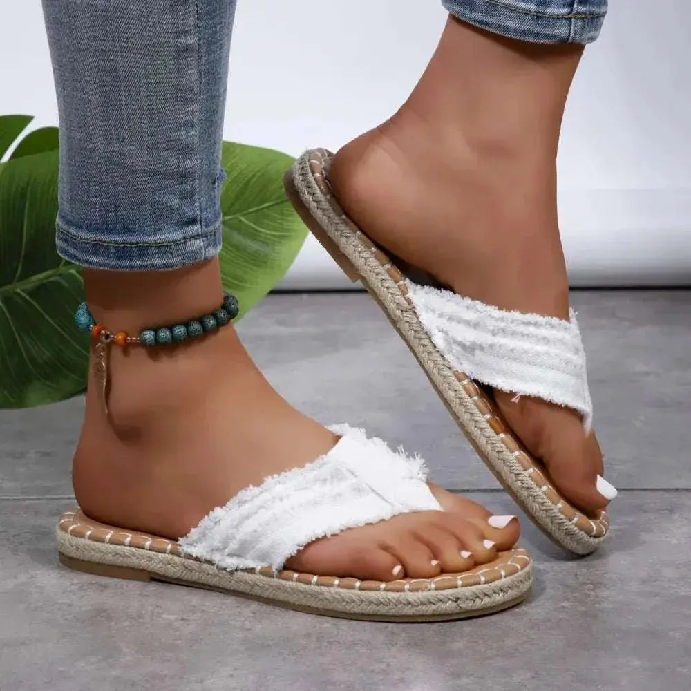 Toe Post Raw Hem Flat Sandals in white canvas with rubber sole.