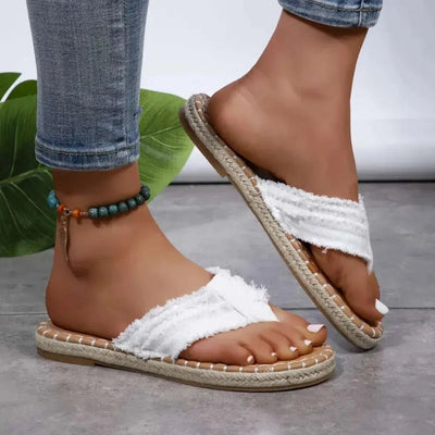 Toe Post Raw Hem Flat Sandals in white canvas with rubber sole.