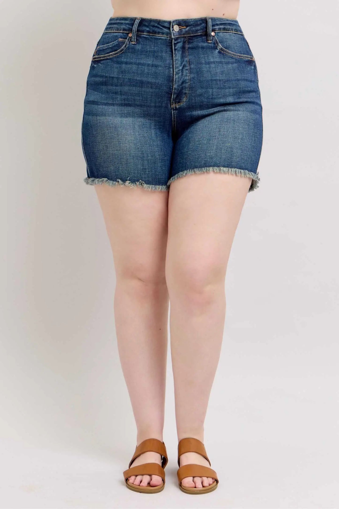 Judy Blue tummy control denim shorts with fray hem and shield back pockets.