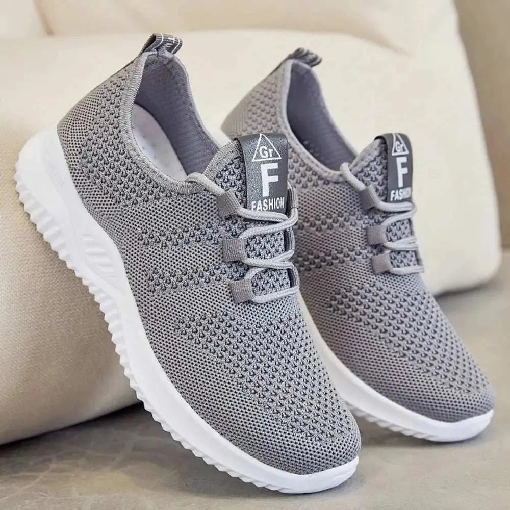 Breathable mesh lace-up athletic shoes, grey with white soles, true to size fit.