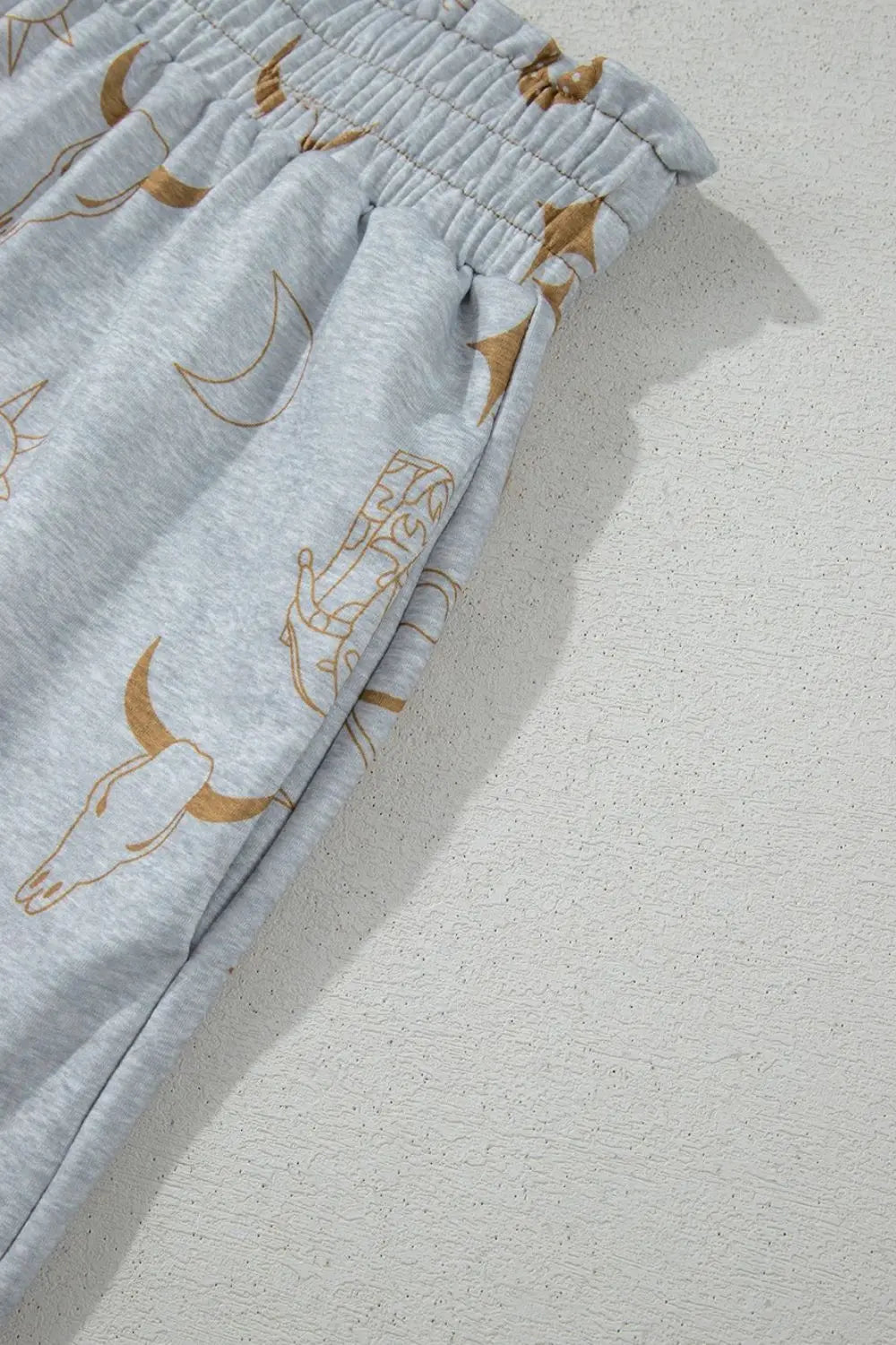 Printed T-shirt and elastic waist shorts with unique graphic design, basic style.
