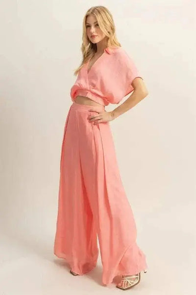 Kimono sleeve crop top and wide leg pants set in pink, showcasing an elegant and modern style.