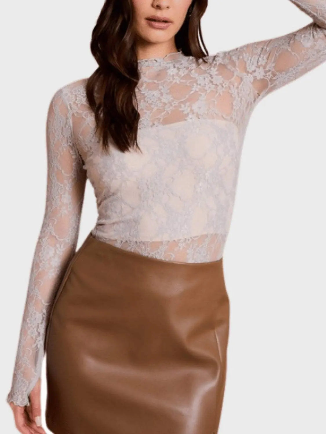Lace mock neck long sleeve top in sheer fabric with slight stretch.