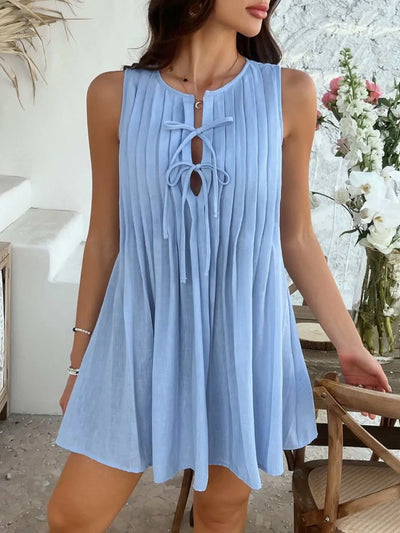 Devine Pleated Sleeveless Mini Dress in blue with tie front and pleated design.