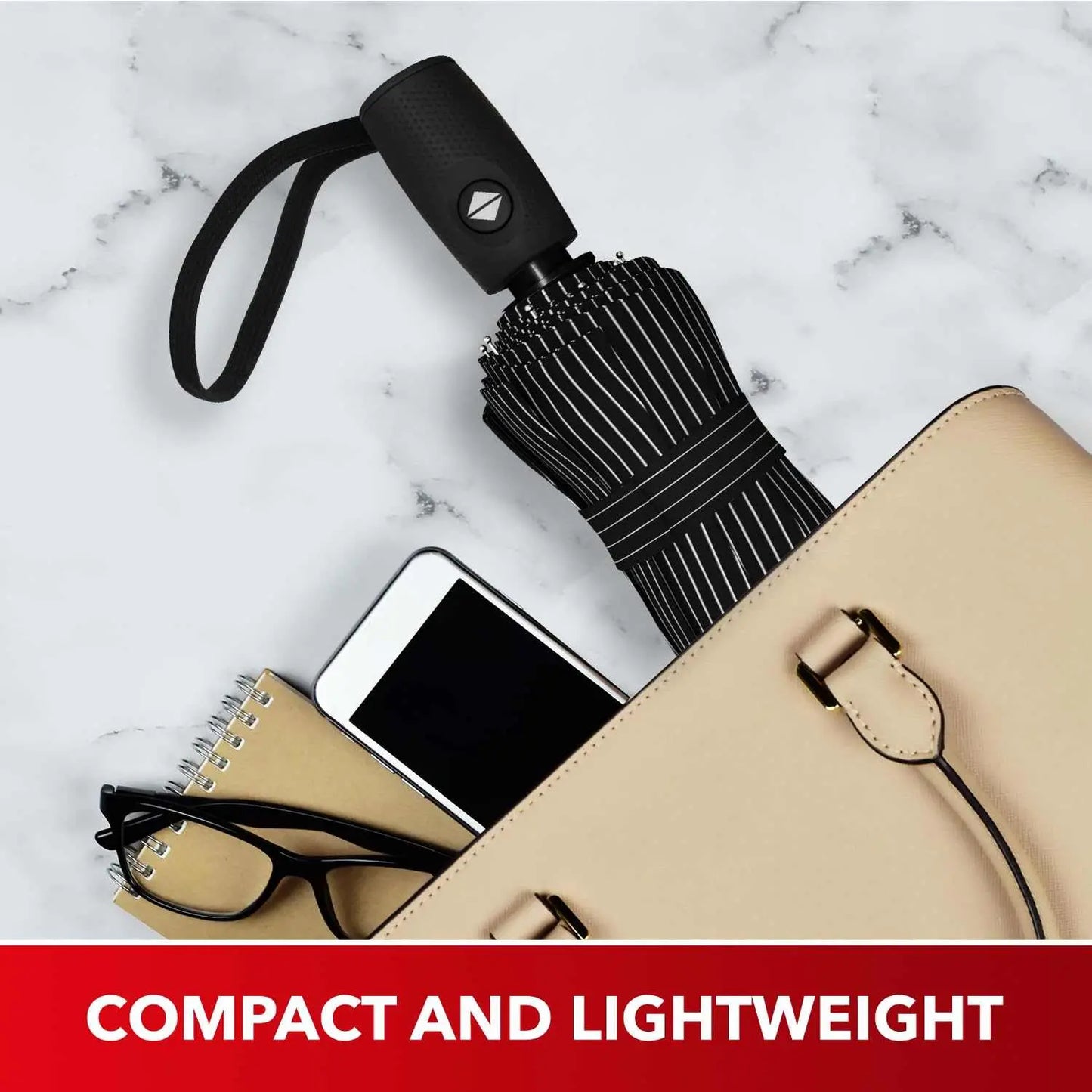 Compact and lightweight Repel Umbrella Windproof Travel Umbrella, ideal for purses and backpacks, displayed on a marble surface.