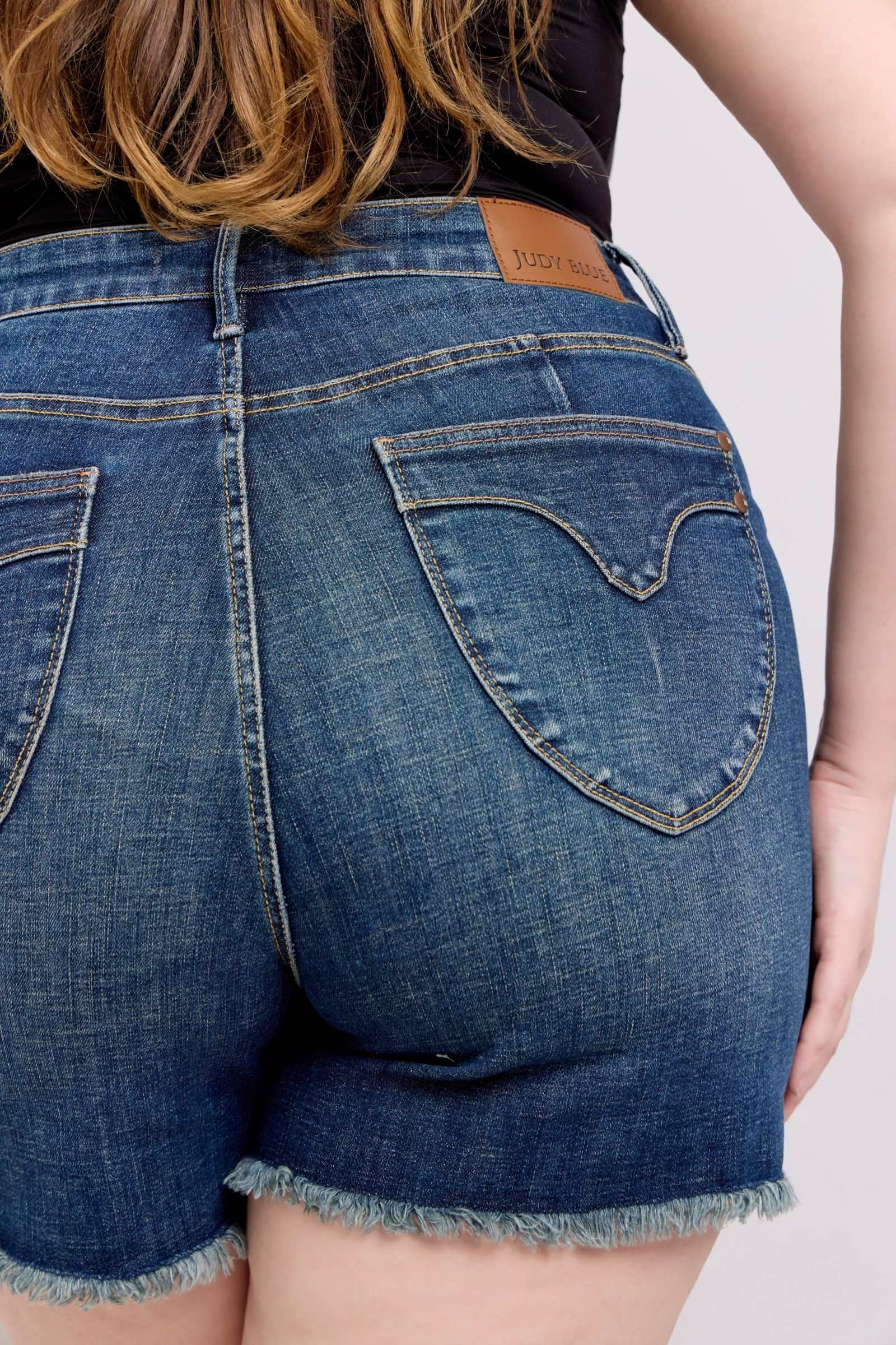 Judy Blue Denim Shorts with Fray Hem and Shield Back Pockets.