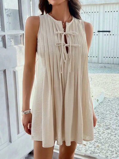 Devine Pleated Sleeveless Mini Dress in beige with tie detail, polyester fabric.