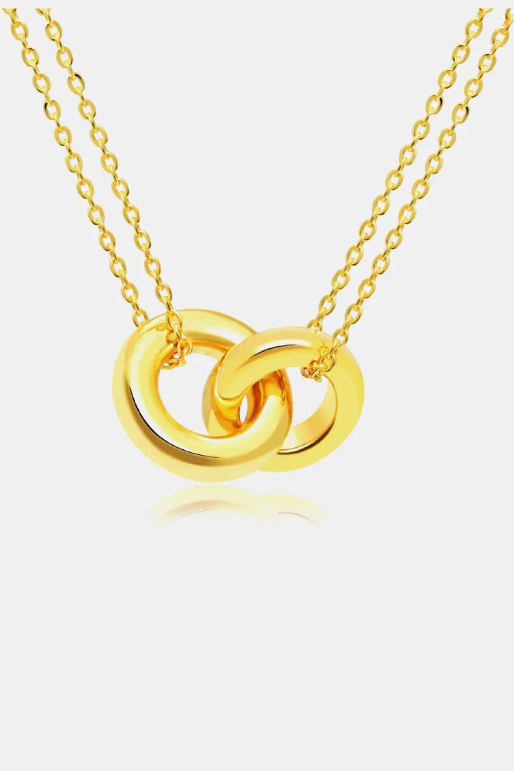 Linked ring pendant chain necklace in brass, elegant design, flat lay style.