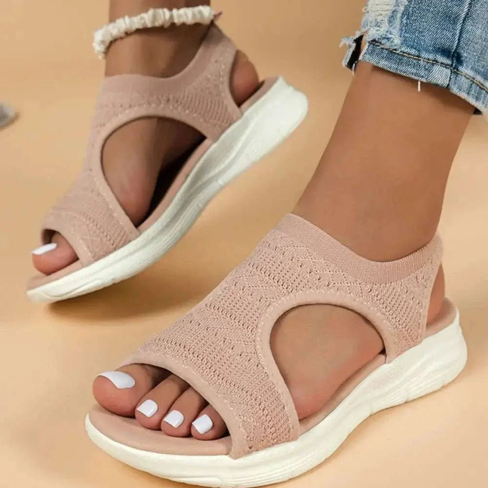 Peep toe solid color sandals in rubber and cloth, flat heel design.