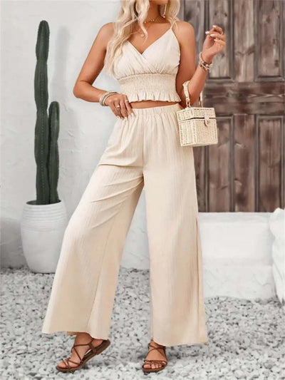 Smocked surplice cami and wide leg pants set in cream, featuring ruffles and a slit design.