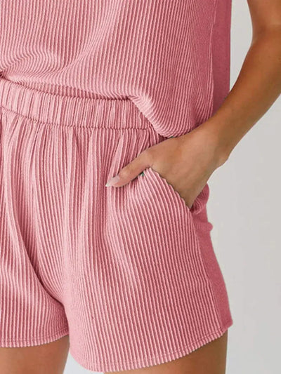 Round neck sleeveless top and shorts set with pocket, ribbed fabric, and slightly stretchy material.