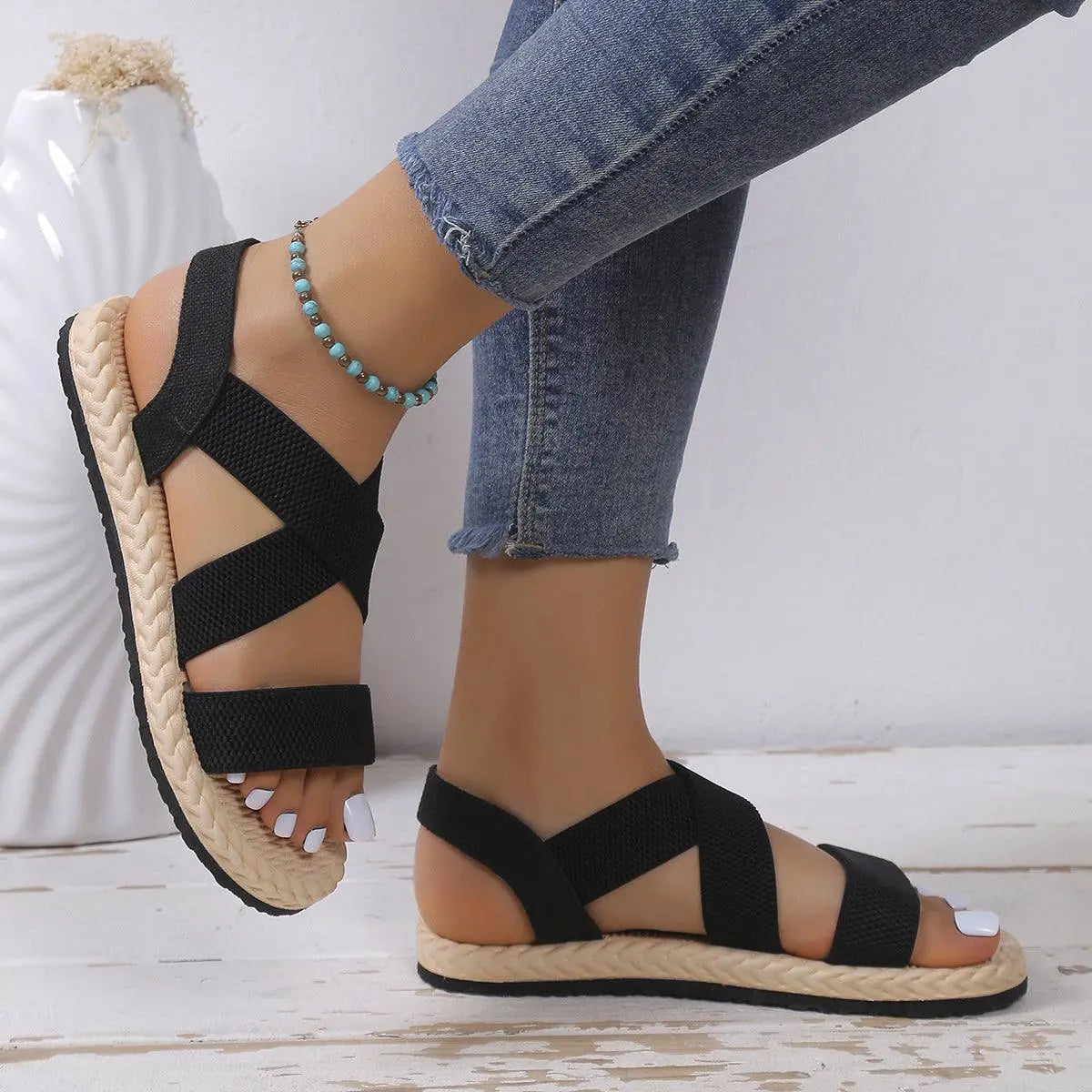 Open toe flats sandals in black with rubber and polyester straps.